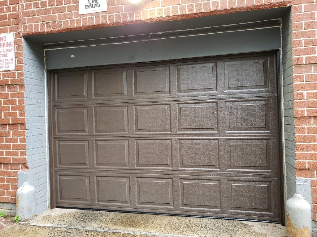 Brown sectional garage door spring repair - Long Island NY